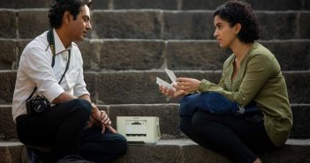 man and woman sitting on step